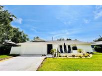 Charming home featuring manicured lawn, fresh exterior paint, and a welcoming front porch at 13290 75Th Ave, Seminole, FL 33776
