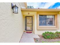 Close-up of the front door with a decorative light fixture, showing the house number and landscaped entrance at 2546 Oakleaf Ln # 35D, Clearwater, FL 33763