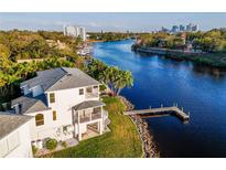 Aerial shot of the home on the river featuring a private dock and nearby city skyline at 2902 N Shoreview Pl, Tampa, FL 33602