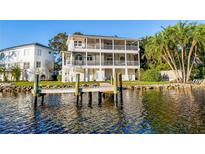 Waterfront home featuring a private dock, multiple decks, and tropical landscaping at 2902 N Shoreview Pl, Tampa, FL 33602