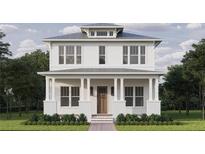Charming two-story home featuring a welcoming front porch with stately columns and a well-manicured lawn at 5327 6Th N Ave, St Petersburg, FL 33710