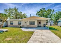 Charming single-story home with a well-maintained lawn and a covered carport at 540 Florida S Cir, Apollo Beach, FL 33572
