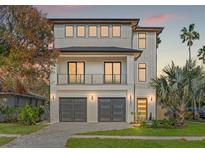 Modern two-story home featuring a sleek design, balcony, and two-car garage, perfect for contemporary living at 531 Danube Ave, Tampa, FL 33606