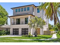 Stunning two-story home with modern design, showcasing a well-manicured lawn and lush landscaping at 531 Danube Ave, Tampa, FL 33606