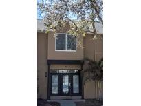 Two-story townhouse featuring a covered front entryway and black framed window at 724 4Th S Ave # 8, St Petersburg, FL 33701