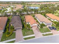 Upscale community featuring pristine landscaping, mature trees, and beautiful lake views at 11563 Callisia Dr, Odessa, FL 33556