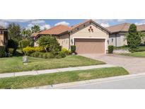 Charming single-story home showcasing a well-manicured lawn and a two-car garage at 11563 Callisia Dr, Odessa, FL 33556