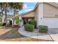 Charming home featuring manicured landscaping, a walkway, and inviting entrance, complemented by a two-car garage and well-kept lawn at 11308 Pocket Brook Dr, Tampa, FL 33635