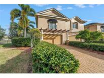 Charming home featuring a manicured lawn, two-car garage, and a welcoming entrance at 650 Saxony Blvd, St Petersburg, FL 33716