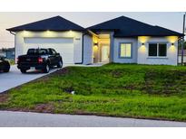 Charming single-story home with well-maintained lawn, attached garage, and modern design features at 13224 Foresman Blvd, Port Charlotte, FL 33981