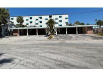 Charming low-rise beachfront property, showcasing a unique mid-century modern design and inviting curb appeal at 50 154Th Ave # 50, Madeira Beach, FL 33708