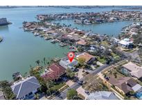 An aerial view shows the canal-front property with private boat dock and surrounding neighborhood at 5836 Skimmer Point S Blvd, Gulfport, FL 33707