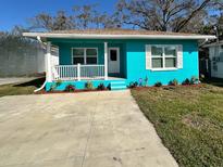 Single-story home featuring a well-manicured lawn, tidy landscaping, and a welcoming entrance at 4811 Haines N Rd, St Petersburg, FL 33714