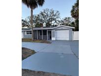 Charming single-story home with attached garage and well-maintained front yard and long driveway at 4935 Amherst Ct, New Port Richey, FL 34652