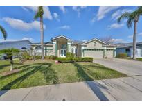 Charming single-Gathering home features lush landscaping, a well-manicured lawn, and an attached two-car garage at 13024 Prestwick Dr, Riverview, FL 33579
