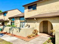 Charming condo with an arched doorway and well-maintained landscaping at 6262 142Nd Ave # 506, Clearwater, FL 33760