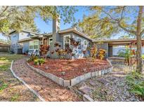 Charming home with a brick walkway, lush landscaping, inviting front porch, and classic chimney at 1157 Brook Rd, Clearwater, FL 33755