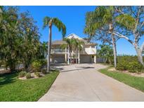 Stunning elevated home featuring a long drive, ample parking, and lush landscaping at 14554 90Th Ave, Seminole, FL 33776