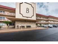 Exterior view of building entrance with parking and small sitting area at 3010 59Th S St # 303, Gulfport, FL 33707