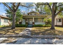 Charming craftsman style home featuring a covered porch, lush landscaping, and a welcoming entrance at 306 S Albany Ave, Tampa, FL 33606