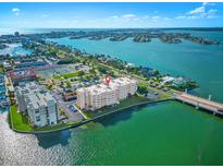 Stunning aerial view of waterfront condos offering beautiful blue water and city views at 500 Treasure Island Cswy # 308, Treasure Island, FL 33706