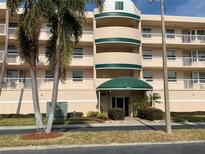 Beautiful condominium exterior with palm trees and manicured landscaping offers a welcoming entrance at 6315 Shoreline Dr # 3204, Seminole, FL 33708