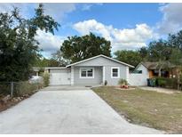 Charming single-story home featuring a well-maintained lawn and a concrete driveway at 8503 N Willow Ave, Tampa, FL 33604