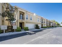 Multi-level townhome shows well with attached garages, neutral color scheme, and tropical landscaping at 3410 Sondrio Cir, Tampa, FL 33611