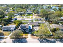 Charming neighborhood aerial view showcasing lush landscaping and proximity to a serene lake at 6342 5Th N Ave, St Petersburg, FL 33710