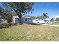 Charming single-story home with a well-manicured lawn and a quaint pink front door at 2709 57Th S St, Gulfport, FL 33707