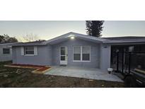 Charming single-story home with a well-manicured lawn, fresh exterior paint, and an inviting front porch at 10835 Felsdale Ave, Port Richey, FL 34668