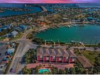 Breathtaking aerial view of waterfront townhomes with a community pool and Gulf access at 3390 W Maritana Dr # 4, St Pete Beach, FL 33706