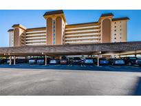 Condominium parking featuring covered spaces under the building in a well lit area at 5130 Brittany S Dr # 201, St Petersburg, FL 33715