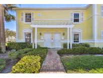 Charming two-story condo with a white pergola and lush landscaping at 4744 Snook Se Dr, St Petersburg, FL 33705