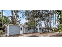 Charming single-story home featuring light blue siding, flower boxes, and a spacious front yard area at 8922 Donna Lu Dr, Odessa, FL 33556