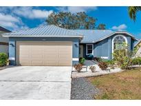 Charming single-Gathering home with a metal roof, a spacious 2-car garage, and manicured landscaping at 1204 50Th E St, Bradenton, FL 34208