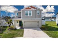 Two-story home with attached two-car garage, well-maintained lawn, and neutral color palette at 13106 Zolo Springs Cir, Riverview, FL 33579
