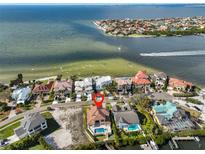 Stunning aerial view of waterfront home with pool, boat dock, and beautiful bay views at 912 Symphony Beach Ln, Apollo Beach, FL 33572