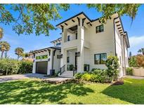 Stunning two-story modern home featuring manicured lawn, elegant black trim, and a convenient two-car garage at 5004 S The Riviera, Tampa, FL 33609