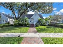 Charming home with beautiful landscaping, mature trees, and brick walkway at 156 21St Ne Ave, St Petersburg, FL 33704