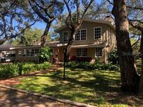 Charming two-story home with mature landscaping and large windows at 2901 Pelham Rd N, St Petersburg, FL 33710