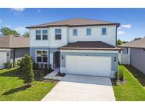 Charming two-story home with manicured lawn, paved driveway, and attached two-car garage at 4227 Big Sky Dr, Spring Hill, FL 34604