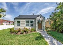Charming home with a lush green lawn, inviting walkway, and freshly painted facade at 4541 2Nd N Ave, St Petersburg, FL 33713
