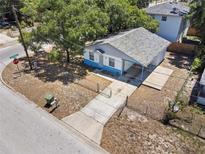 Charming home features a covered carport, fenced yard, and a well-maintained lawn at 5511 N 32Nd St, Tampa, FL 33610