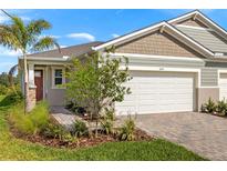 Charming single-Gathering home with a brick driveway and a two-car garage, enhanced by lush landscaping at 6224 Timberdale Ave, Wesley Chapel, FL 33545