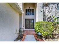 Elegant home entrance with decorative glass doors and a transom window at 18126 Kara Ct, Tampa, FL 33647
