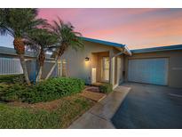 Charming home features lush landscaping, mature palms, and a welcoming entrance at 2731 Sherbrooke Ln # D, Palm Harbor, FL 34684