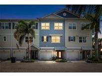 Charming townhome exterior featuring well-manicured landscaping, private garages, and a welcoming facade at twilight at 3226 Nautical S Pl, St Petersburg, FL 33712