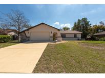 Charming single-story home boasting a two-car garage, neutral paint, and a well-manicured lawn at 11304 Sedgefield Ave, Spring Hill, FL 34608