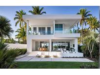 Stunning two-story modern home with balcony, patio, and lush tropical landscaping at 902 W Fribley St, Tampa, FL 33603